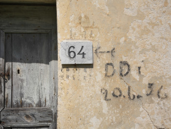 Diddittì 56 Monte Pino, Muddizza Piana - Comune di Olbia  Particolare esterno di stazzo disabitato, scritte residuali della campagna di disinfestazione con D.D.T. del 1956, sullo sfondo la vecchia porta